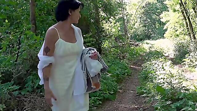Older woman masturbates and fucks in the forest
