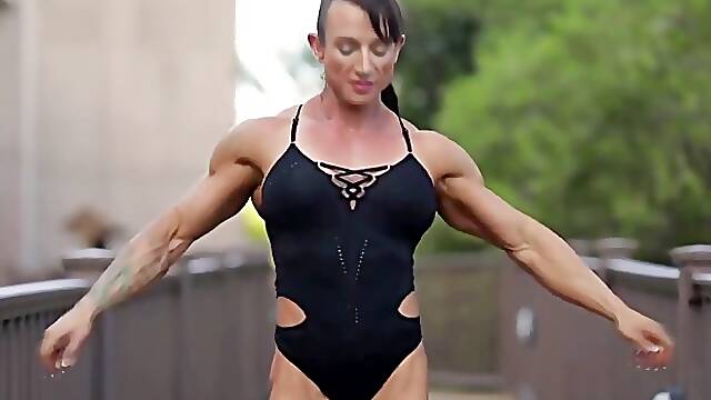 Muscled woman is posing outdoors in the middle of the day and it feels so good