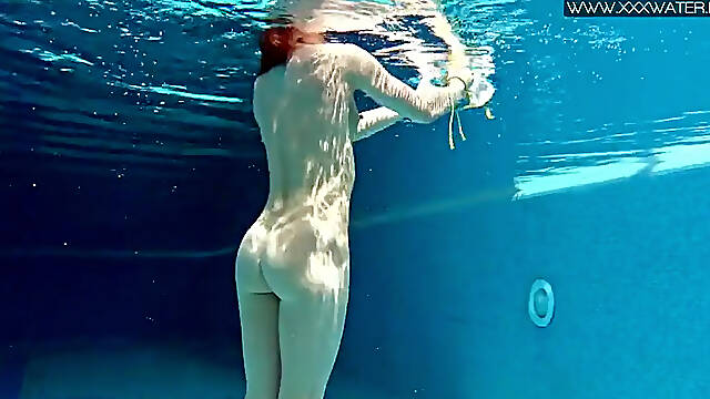 Skinny MILF Nicole Pearl shakes her ass underwater in a public pool