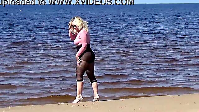 Funny MILF sucks and shows off big tits at the beach