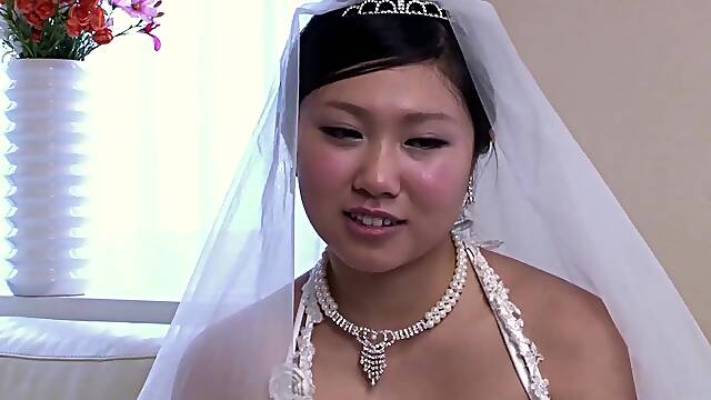 The fresh Oriental bride remains attired in her bridal gown through a visitor's arrival