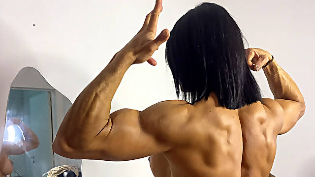 Female Fitness Model Flexes Huge Biceps &amp; Back Muscles