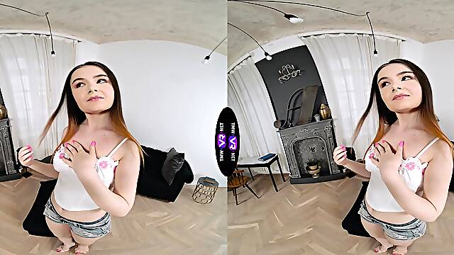 A sexy girl with long hair is trying on her new shorts.